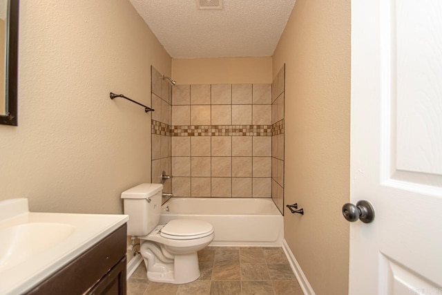 full bathroom featuring vanity, toilet, a textured ceiling, and tiled shower / bath