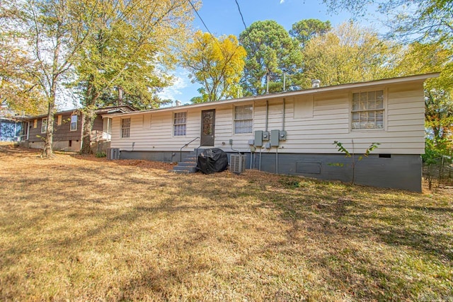 view of front of property featuring a front yard and central air condition unit