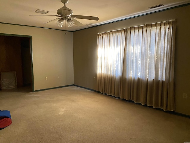 carpeted spare room with ceiling fan