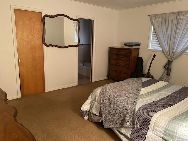 bedroom with dark colored carpet and ensuite bath