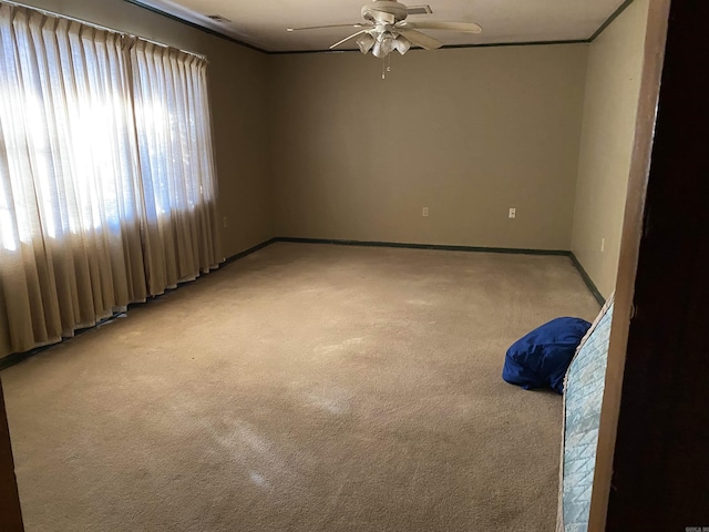 empty room with ceiling fan and carpet floors