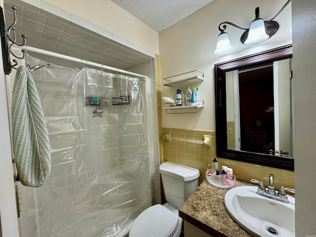 bathroom with a textured ceiling, a shower with shower curtain, toilet, tile walls, and vanity