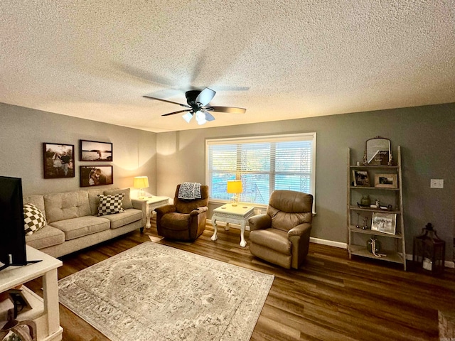 living room with a textured ceiling, ceiling fan, and dark hardwood / wood-style flooring