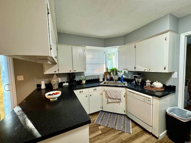 kitchen featuring dishwasher, white cabinetry, a textured ceiling, and light wood-type flooring