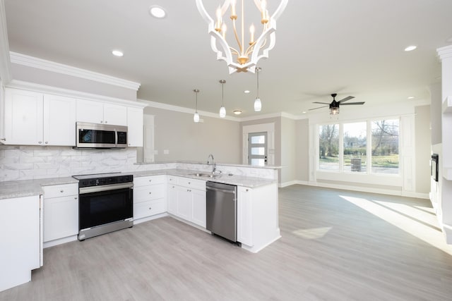 kitchen featuring white cabinetry, stainless steel appliances, kitchen peninsula, and pendant lighting