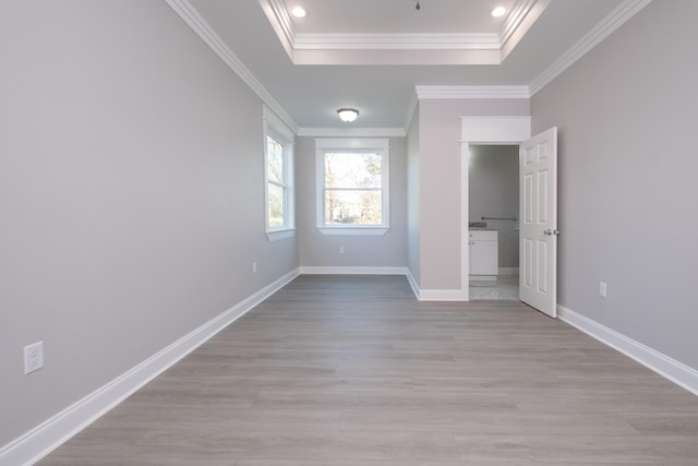unfurnished bedroom with crown molding, a raised ceiling, and light hardwood / wood-style floors