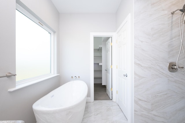 bathroom featuring independent shower and bath