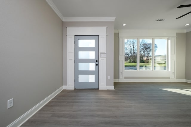foyer with crown molding, ceiling fan, and dark wood-type flooring