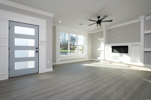 unfurnished living room with crown molding, ceiling fan, wood-type flooring, and built in shelves