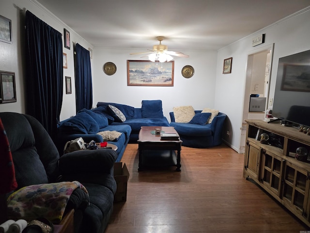 living room with ornamental molding, ceiling fan, and dark hardwood / wood-style flooring