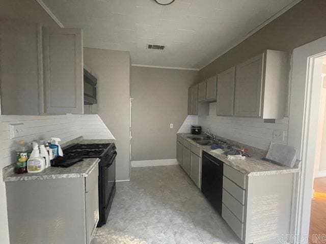 kitchen with backsplash, ornamental molding, black appliances, sink, and gray cabinets