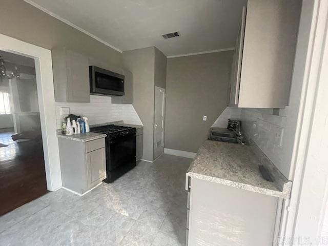 kitchen featuring black electric range, crown molding, decorative backsplash, and sink