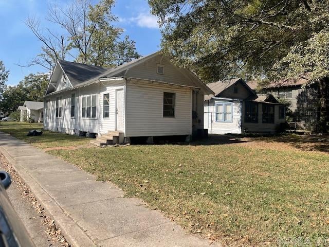 view of property exterior with a yard