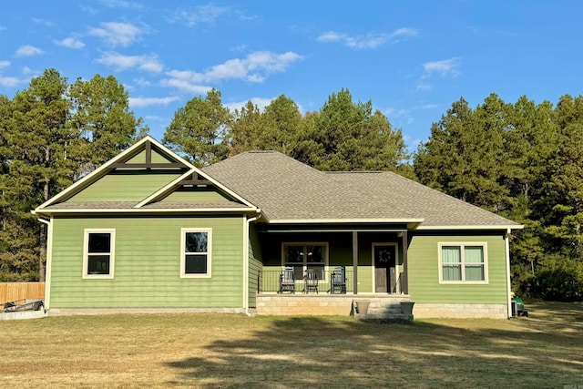 view of front of house with covered porch and a front yard