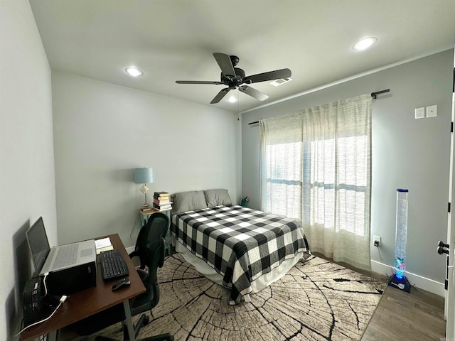 bedroom with ceiling fan and hardwood / wood-style flooring