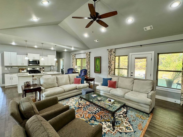 living room featuring ceiling fan, high vaulted ceiling, sink, and dark hardwood / wood-style floors