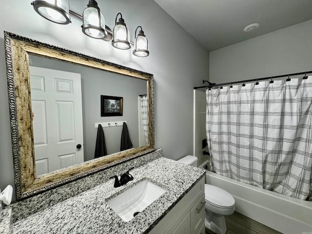 full bathroom featuring vanity, shower / bath combo, hardwood / wood-style flooring, and toilet