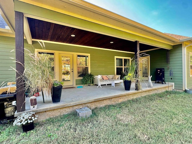 rear view of property featuring a yard and a patio