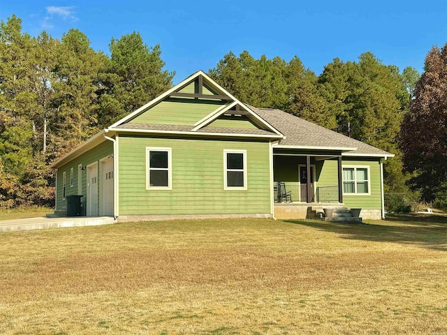 rear view of house featuring a lawn