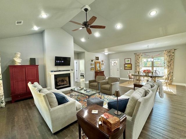 living room featuring dark wood-type flooring, ceiling fan, and high vaulted ceiling