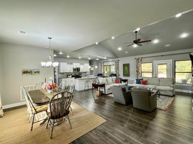 dining room featuring high vaulted ceiling, sink, dark hardwood / wood-style floors, and ceiling fan with notable chandelier