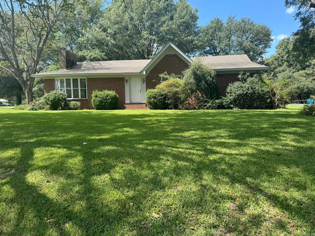 ranch-style home with a front lawn