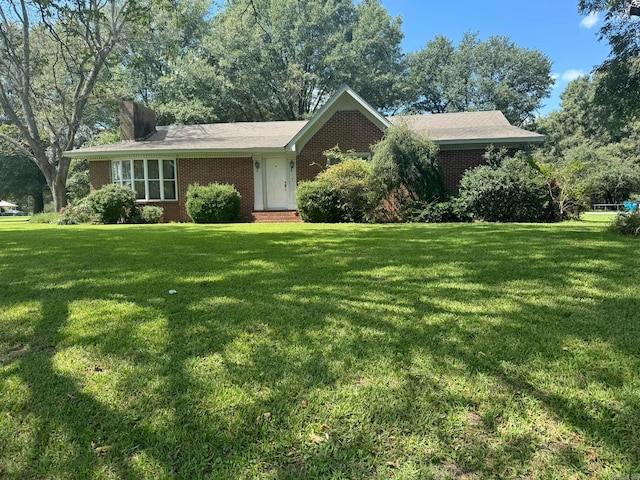 ranch-style home with a front lawn