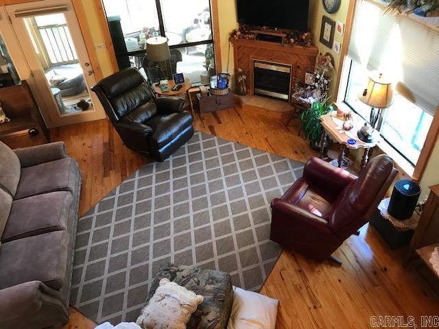 living room with wood finished floors and a fireplace