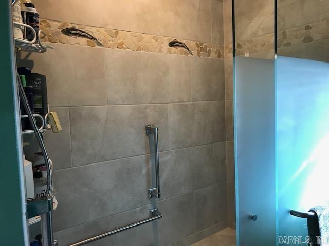 bathroom with tiled shower