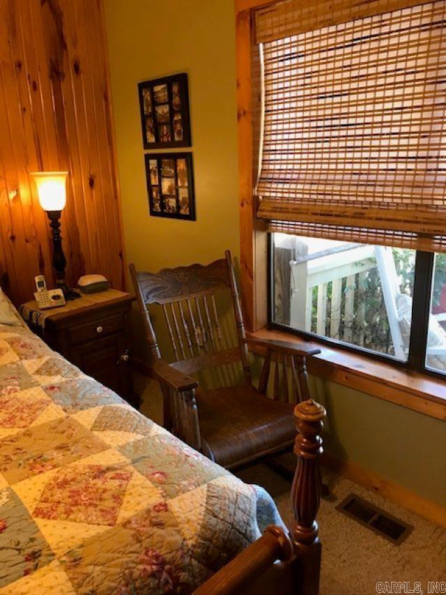 bedroom featuring carpet floors and visible vents