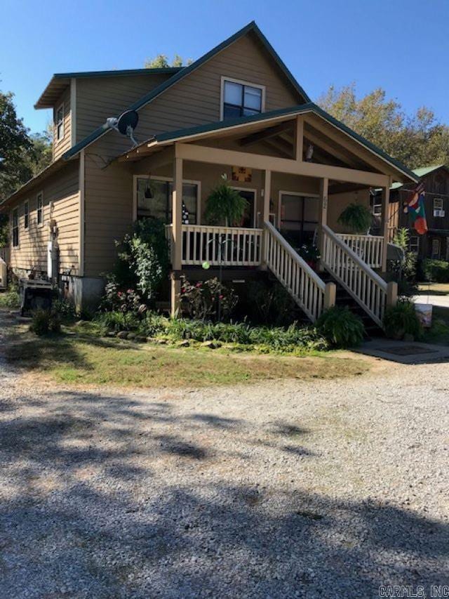 view of front of property with a porch and stairway
