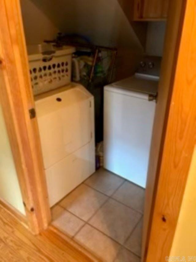 laundry room featuring tile patterned flooring and separate washer and dryer