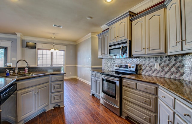 kitchen with stainless steel appliances, dark stone countertops, sink, crown molding, and dark hardwood / wood-style flooring