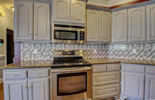 kitchen with ornamental molding, tasteful backsplash, and stainless steel appliances