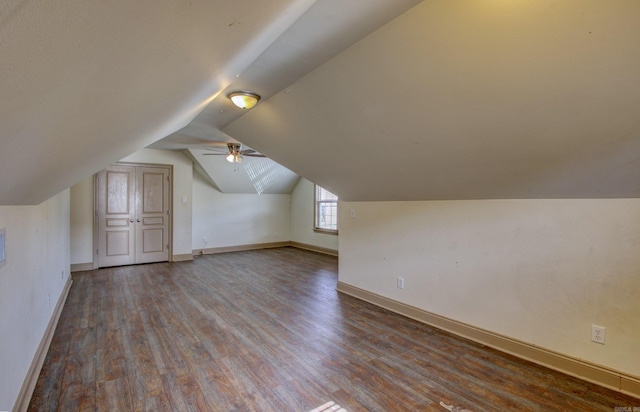 additional living space featuring wood-type flooring and vaulted ceiling