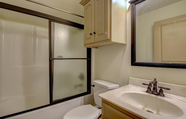 full bathroom with vanity, enclosed tub / shower combo, and toilet