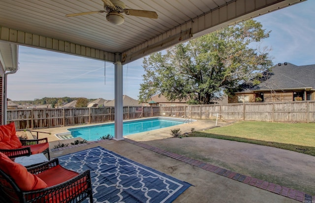 view of swimming pool featuring a patio, ceiling fan, and a yard