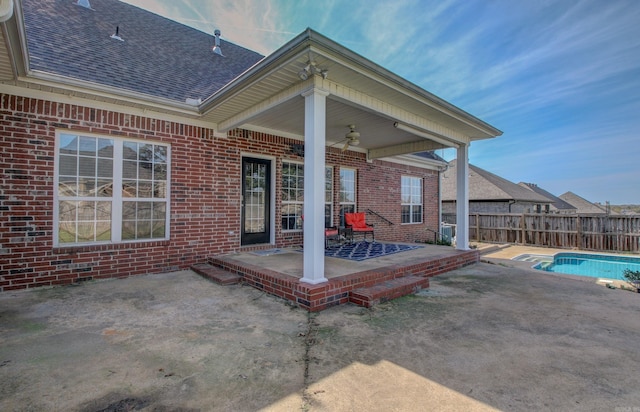 view of patio / terrace featuring a fenced in pool and ceiling fan