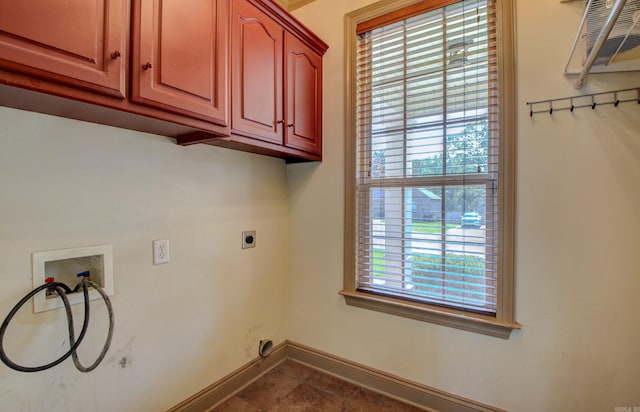 laundry area with hookup for an electric dryer, washer hookup, and cabinets