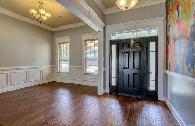 foyer with an inviting chandelier, crown molding, and dark hardwood / wood-style floors