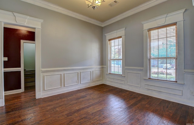 spare room featuring crown molding, plenty of natural light, and dark hardwood / wood-style floors