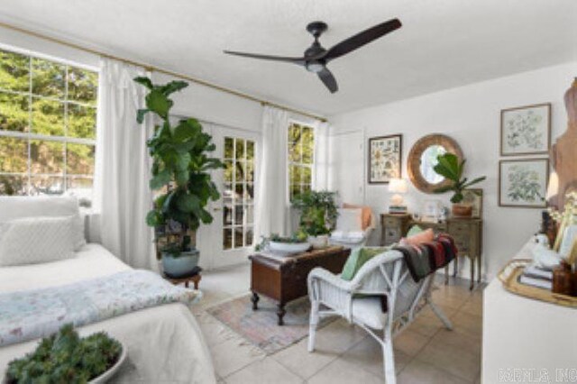 bedroom with multiple windows, light tile patterned floors, and ceiling fan