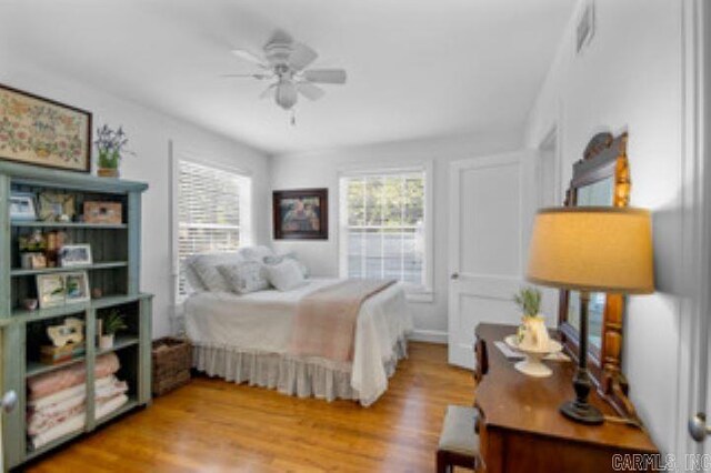 bedroom with light wood-type flooring and ceiling fan