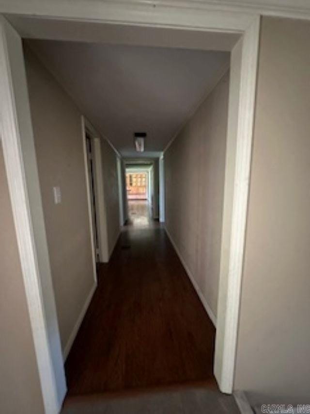 corridor featuring hardwood / wood-style floors and vaulted ceiling