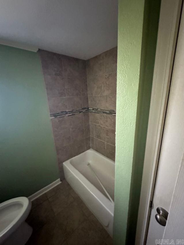 bathroom featuring toilet, tile patterned floors, and separate shower and tub