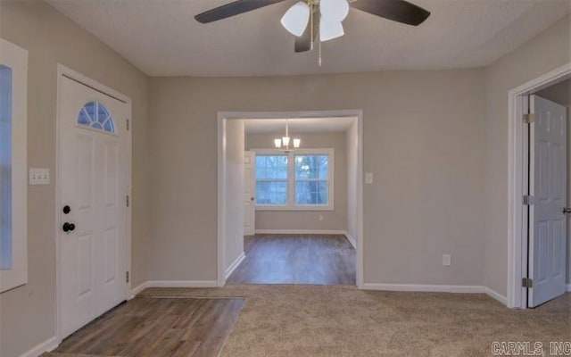 entrance foyer with wood-type flooring and ceiling fan with notable chandelier