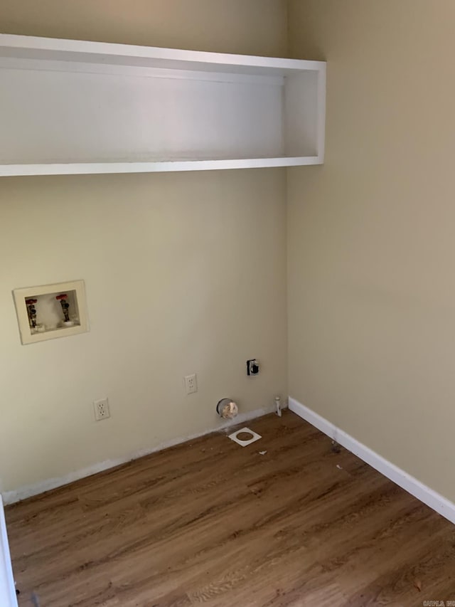 clothes washing area with dark hardwood / wood-style flooring, hookup for a gas dryer, and hookup for a washing machine