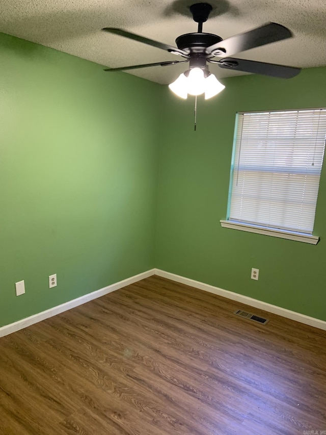 spare room featuring hardwood / wood-style floors, a textured ceiling, and ceiling fan