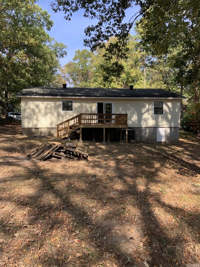 rear view of house featuring a deck