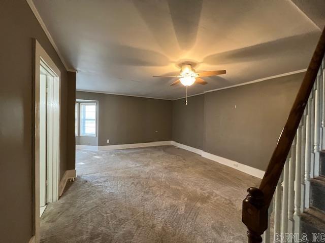 919 E Hamilton Ave, Wynne, AR 72396 - spare room featuring a ceiling fan, crown molding, stairway, baseboards, and carpet flooring